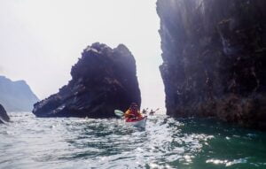 A person in a canoe in the water Description automatically generated