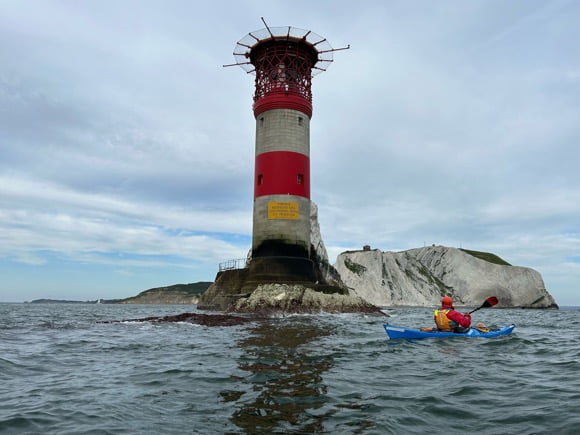 A person in a kayak in the water Description automatically generated