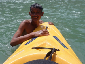 A child in a kayak Description automatically generated