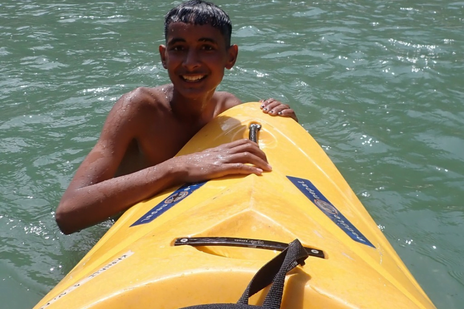 A child in a kayak Description automatically generated