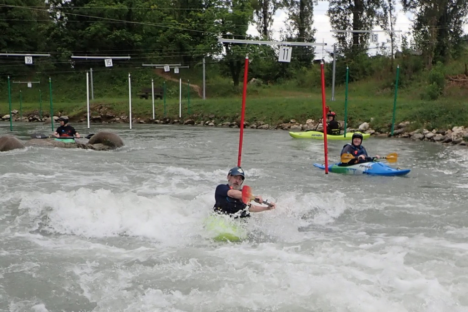 A group of people in kayaks in a river Description automatically generated