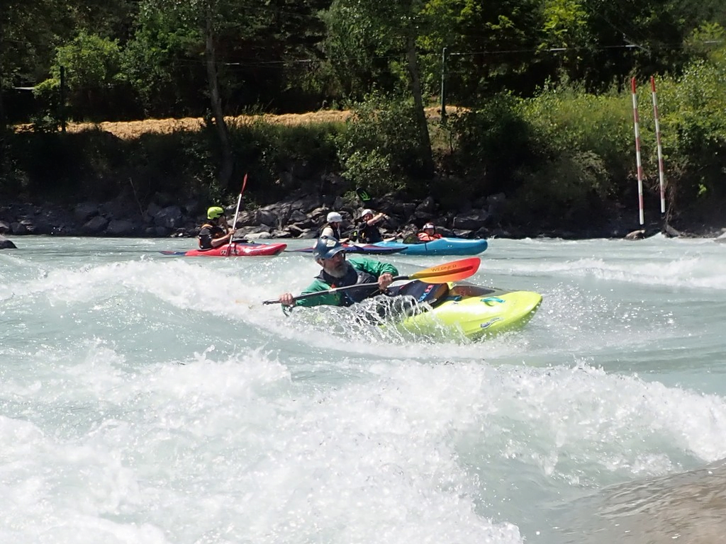 A group of people in kayaks on a riverDescription automatically generated
