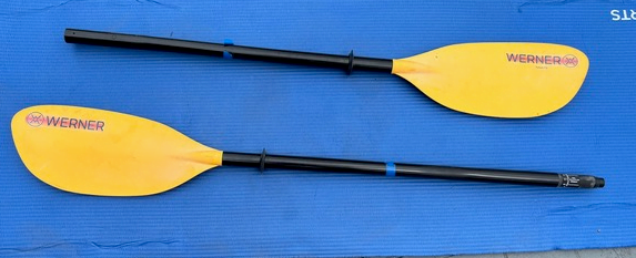 A pair of yellow paddles on a blue surface Description automatically generated