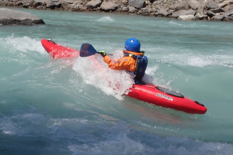 A person in a kayak in the water Description automatically generated