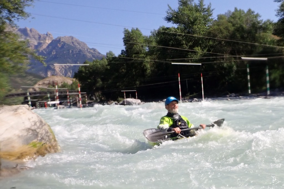 A person in a kayak in a river Description automatically generated