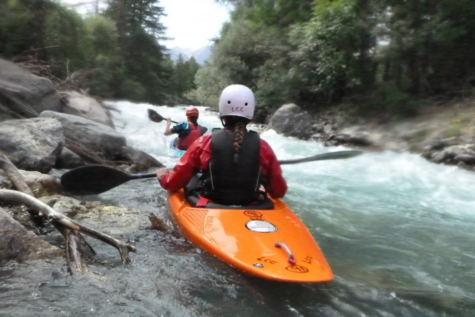 People kayaking in a river Description automatically generated