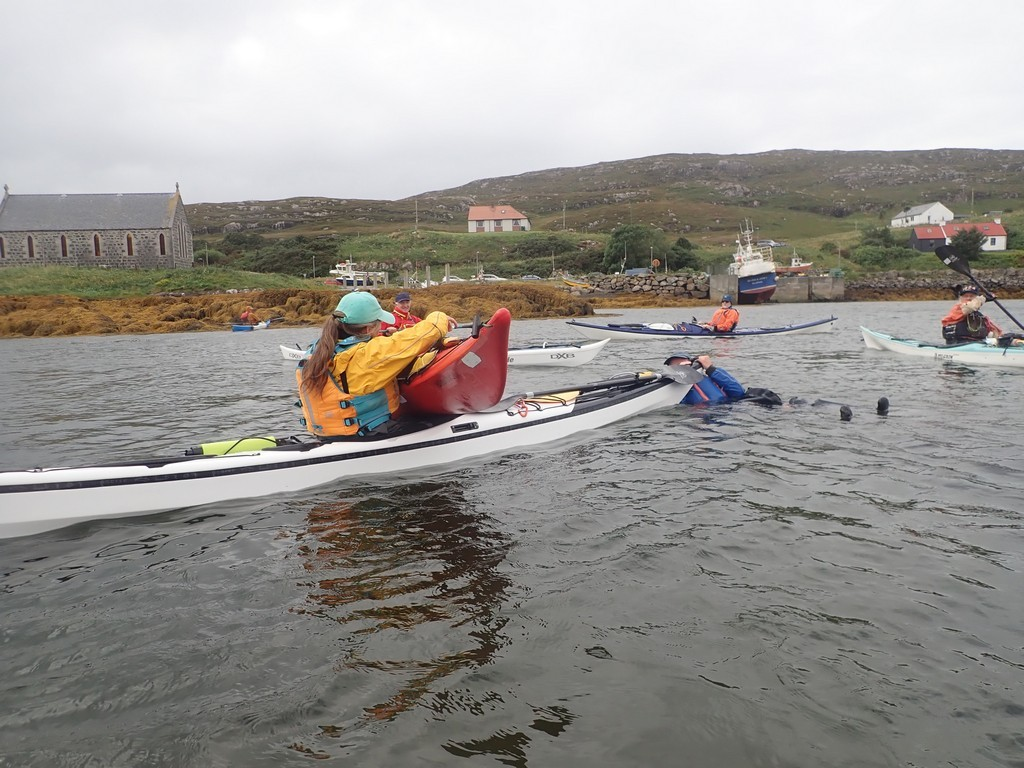 A group of people in a canoeDescription automatically generated