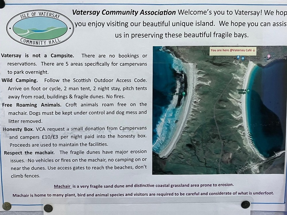 A sign with a map of the islandDescription automatically generated