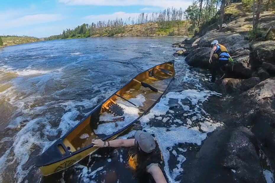 A group of people in a canoe in a river Description automatically generated