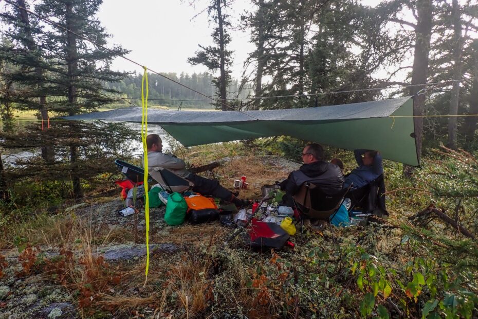 A group of people sitting under a tent Description automatically generated