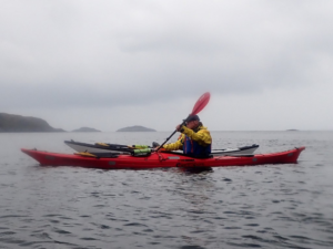 A person in a kayak on the water Description automatically generated