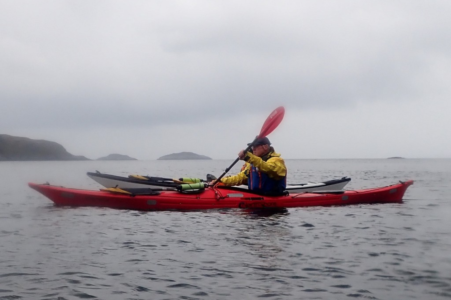 A person in a kayak on the water Description automatically generated