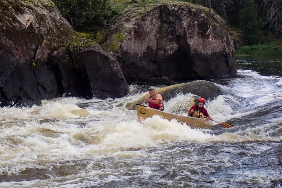 People kayaking in a river Description automatically generated