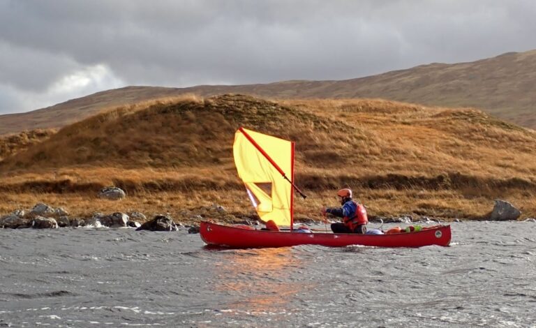 A person in a boat on the water Description automatically generated