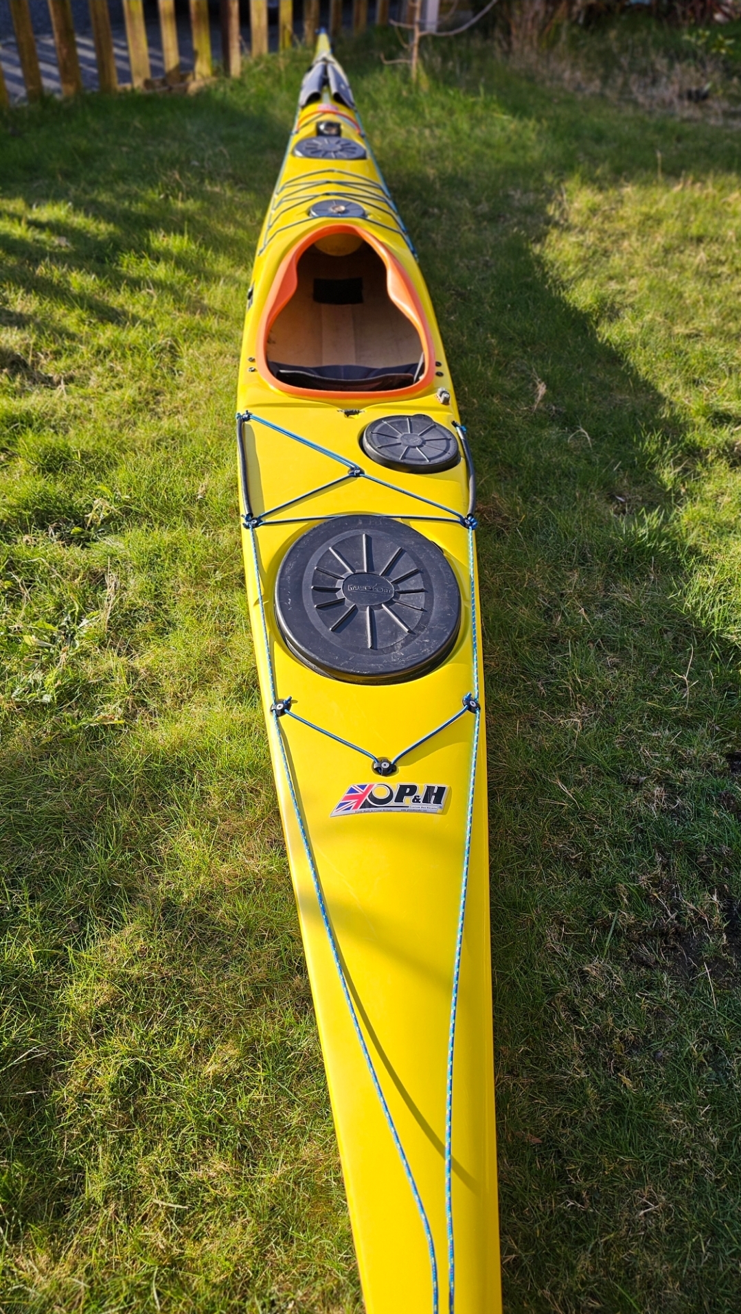 A yellow kayak on grassAI-generated content may be incorrect.