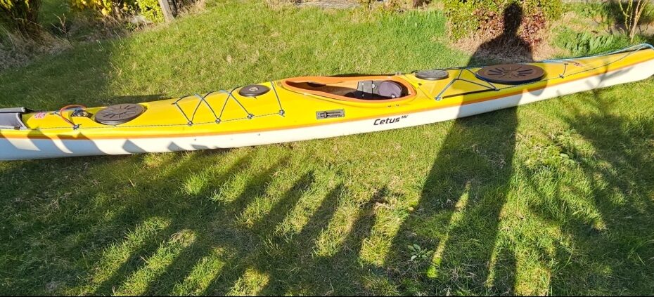 A yellow kayak on grass AI-generated content may be incorrect.