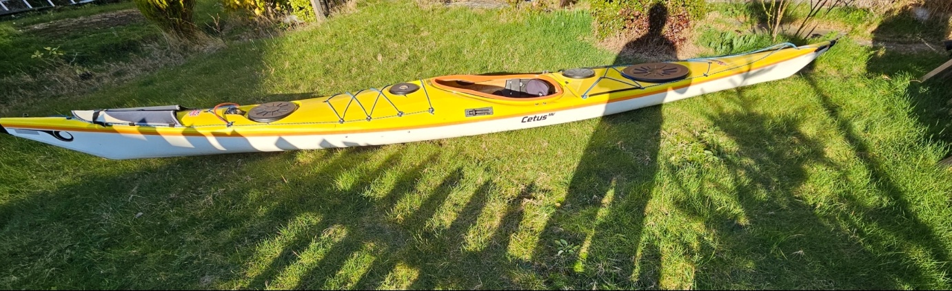 A yellow kayak on grassAI-generated content may be incorrect.