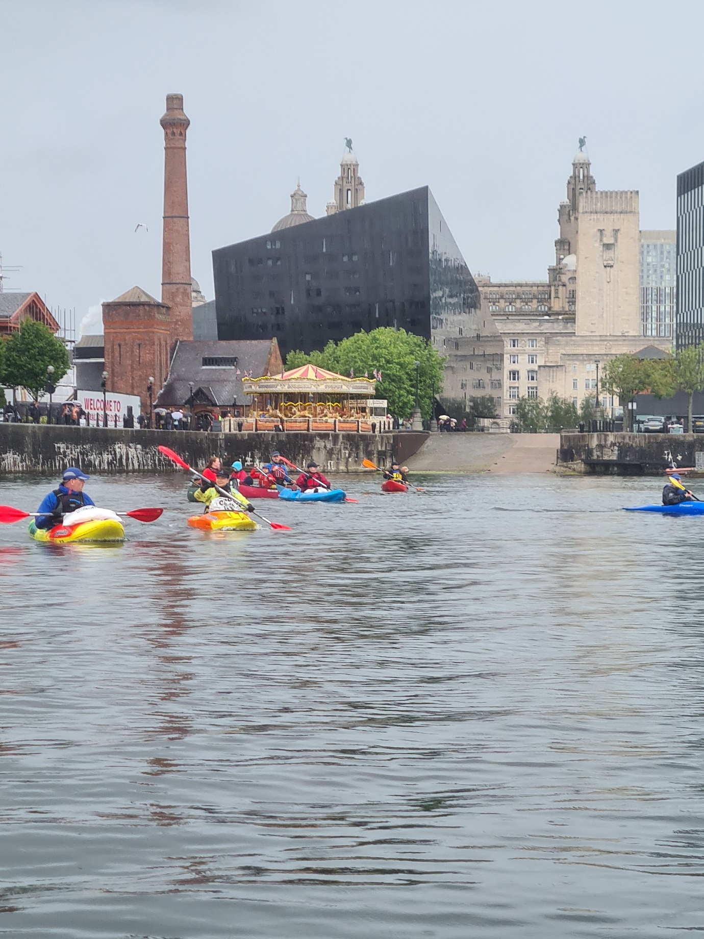 People kayaking in a riverAI-generated content may be incorrect.