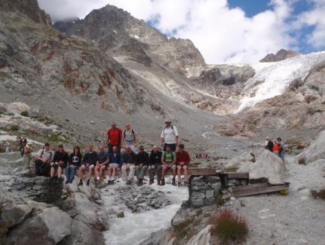 A group of people sitting on rocks Description automatically generated