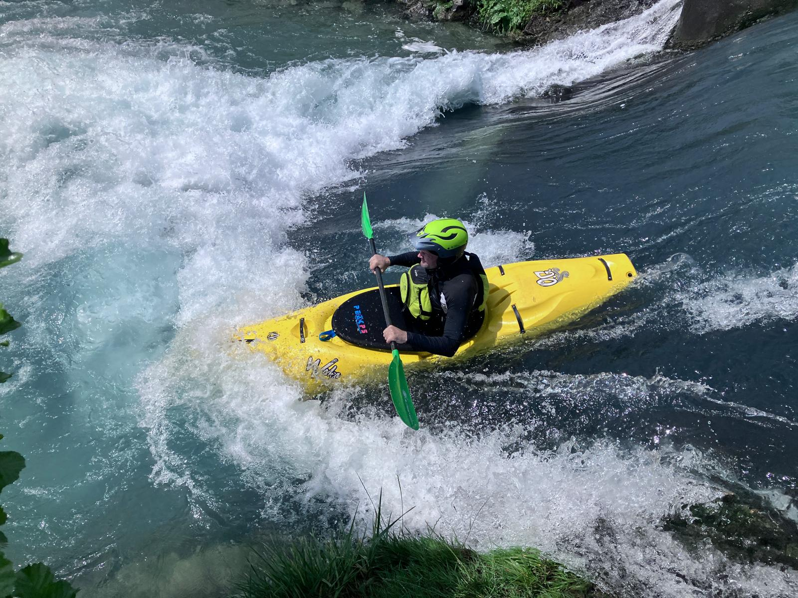 A person in a kayak on a riverAI-generated content may be incorrect.