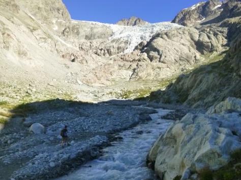 A river running through a rocky valley Description automatically generated