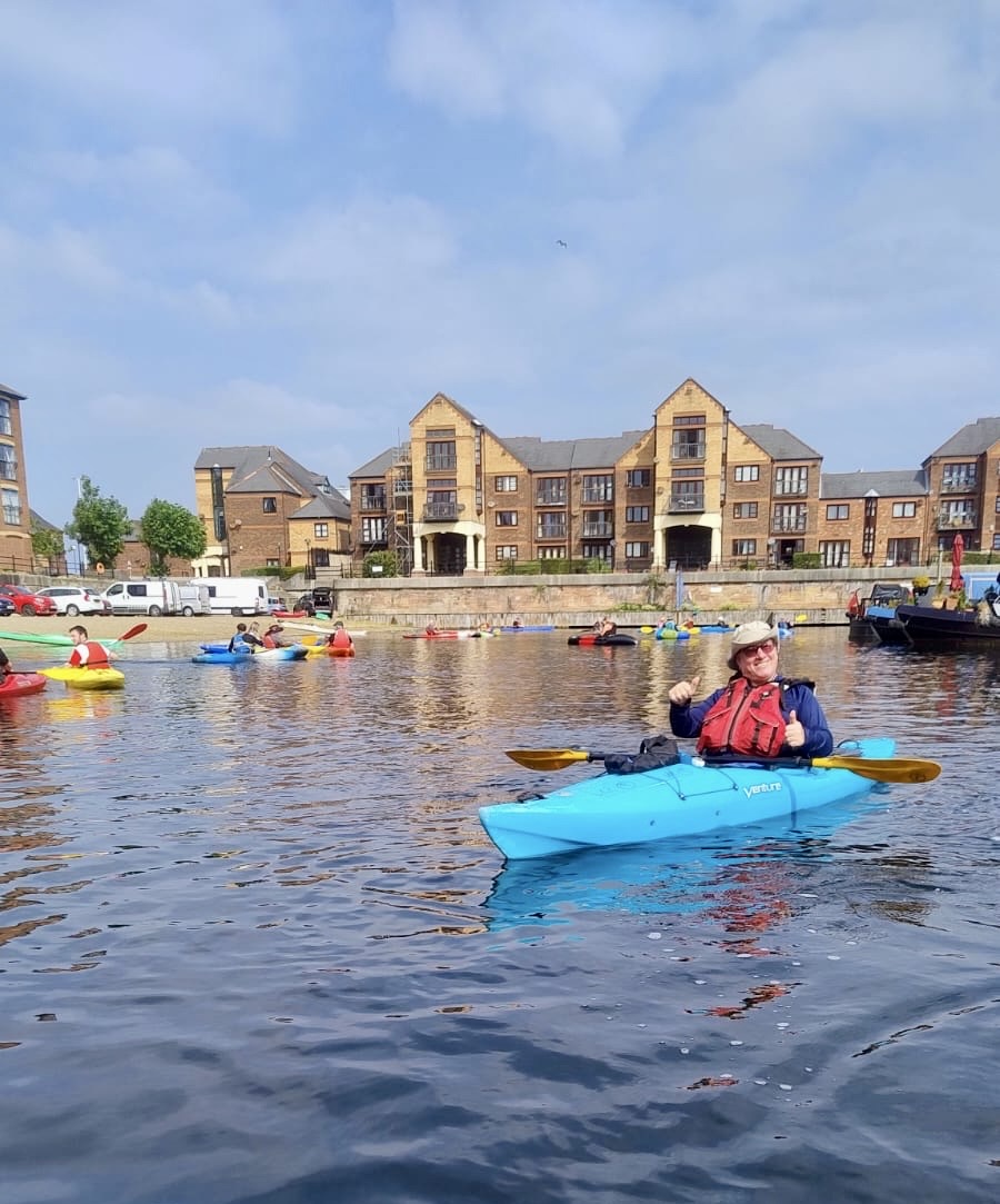 A person in a kayak on a body of waterAI-generated content may be incorrect.