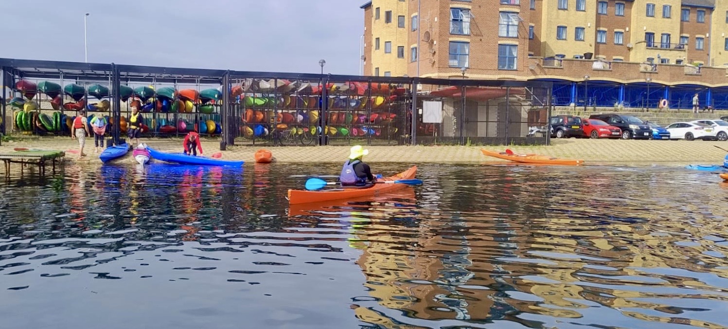 A person in a kayak on a body of waterAI-generated content may be incorrect.