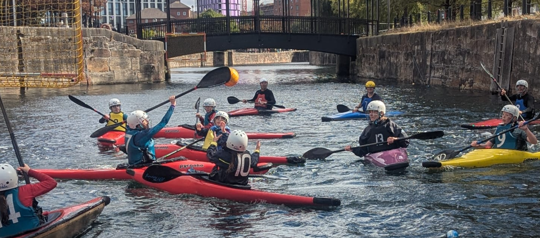 A group of people in kayaks on a riverAI-generated content may be incorrect.