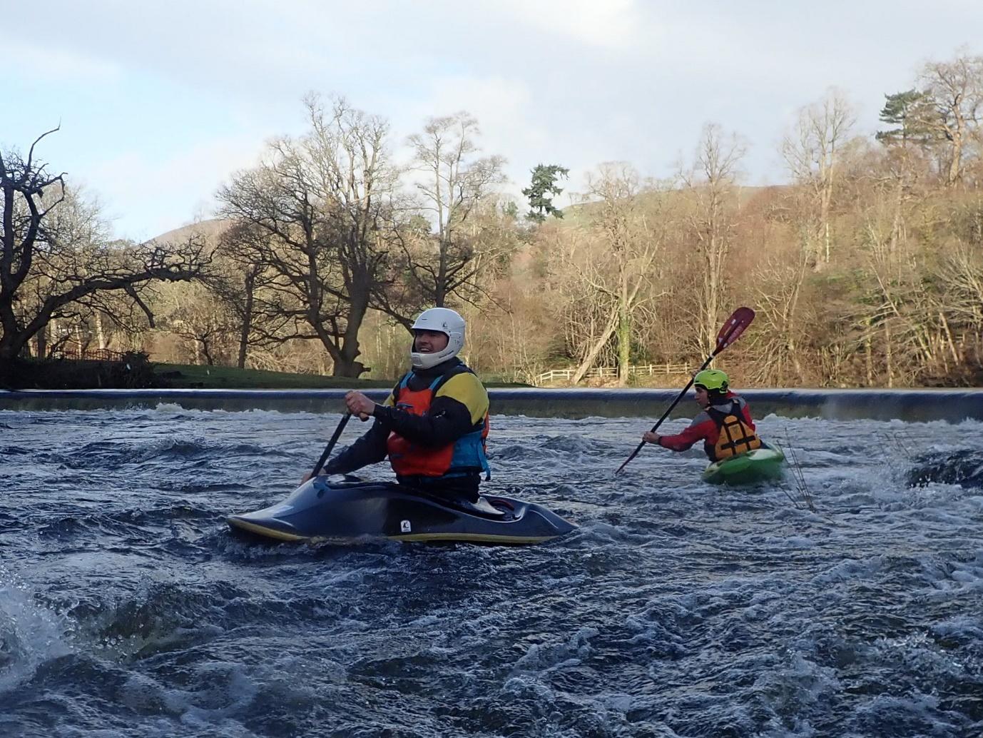 A group of people in kayaks on a river

Description automatically generated with low confidence
