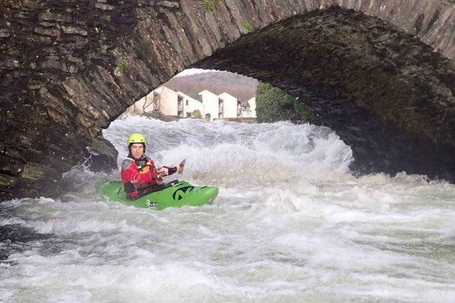 A person kayaking in a river Description automatically generated with low confidence