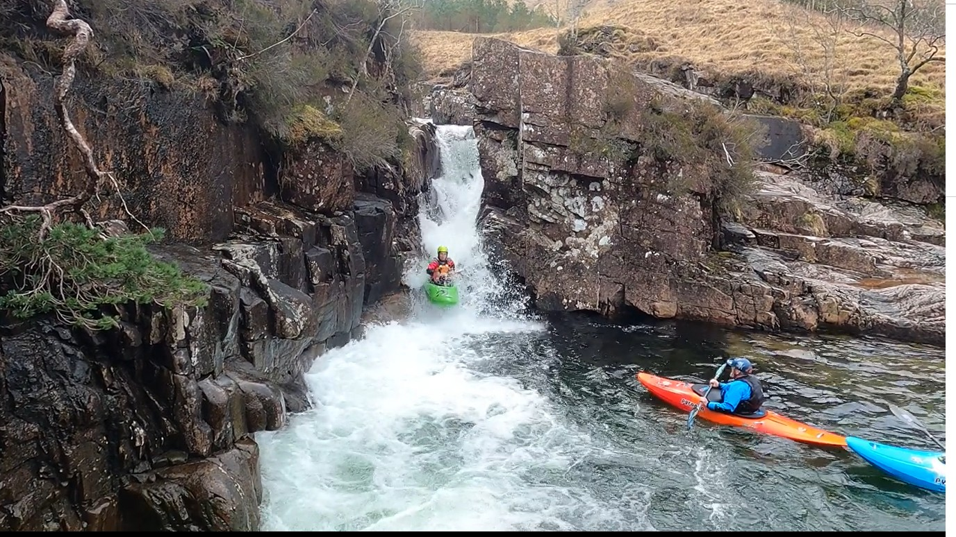A group of people in kayaks in a river with a waterfall

Description automatically generated with low confidence