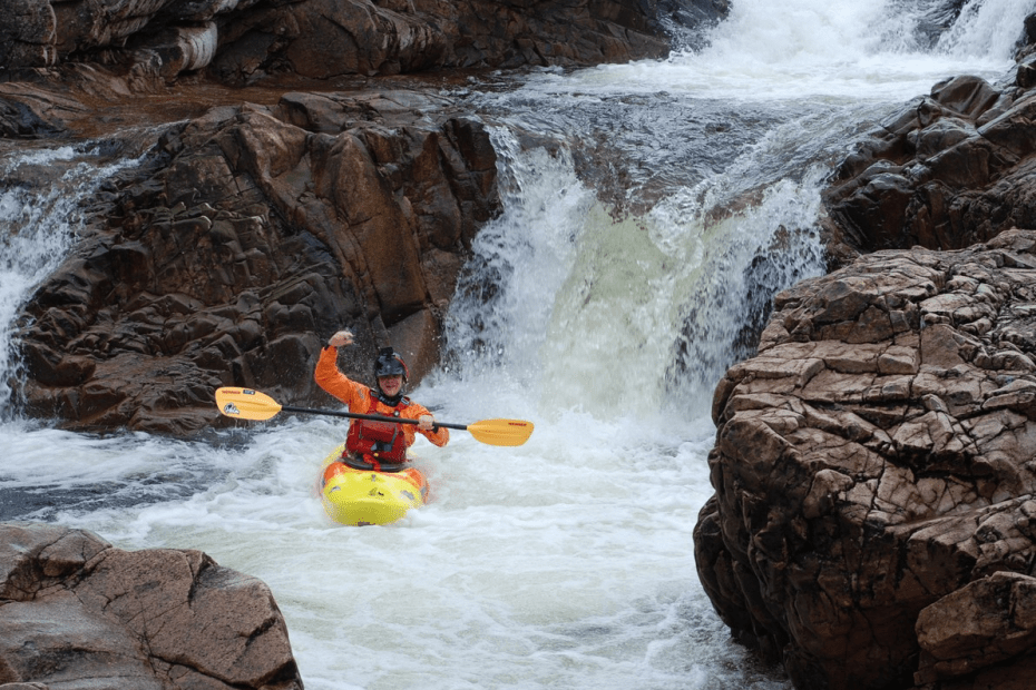 A person in a kayak in a river Description automatically generated with low confidence