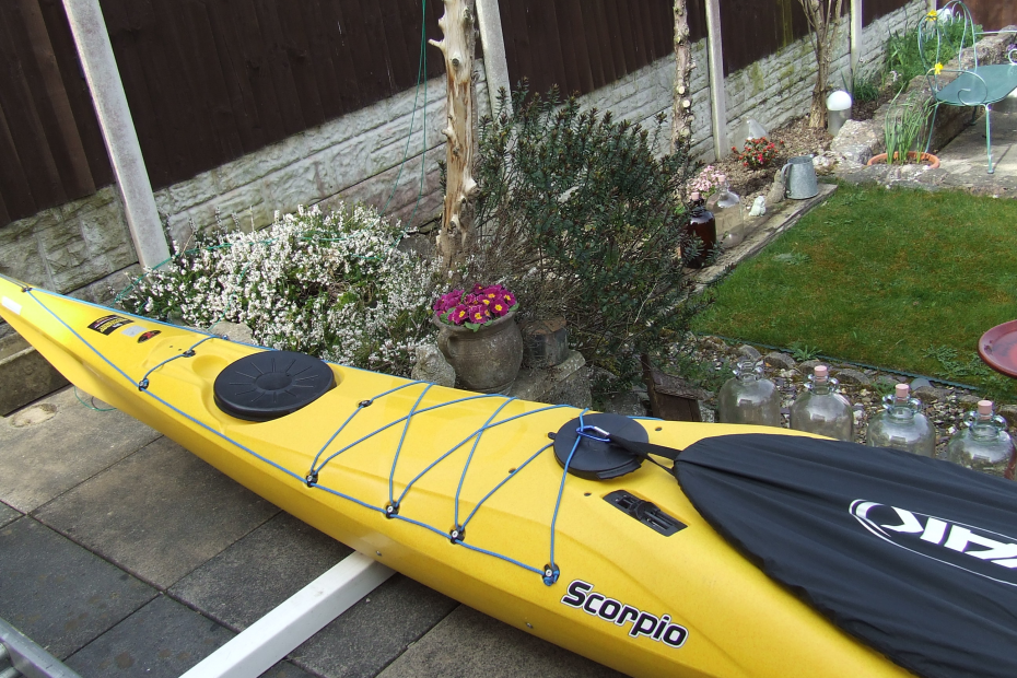 A yellow kayak on a deck Description automatically generated with low confidence