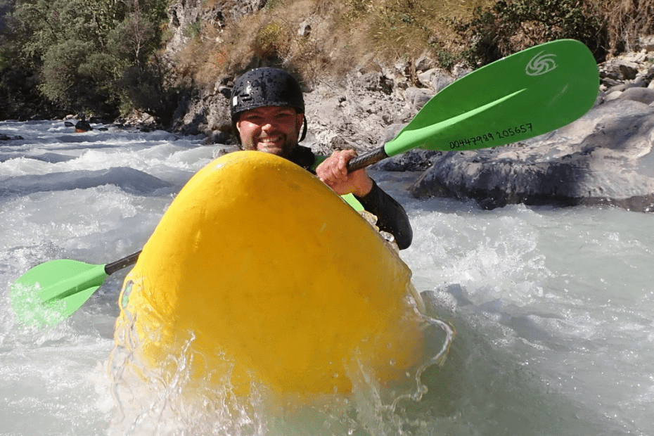 A person kayaking in a river Description automatically generated with medium confidence