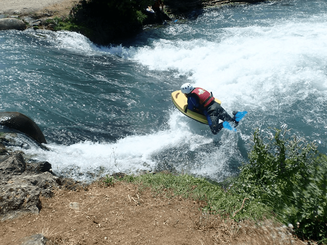 A picture containing outdoor, water, wave, raft

Description automatically generated