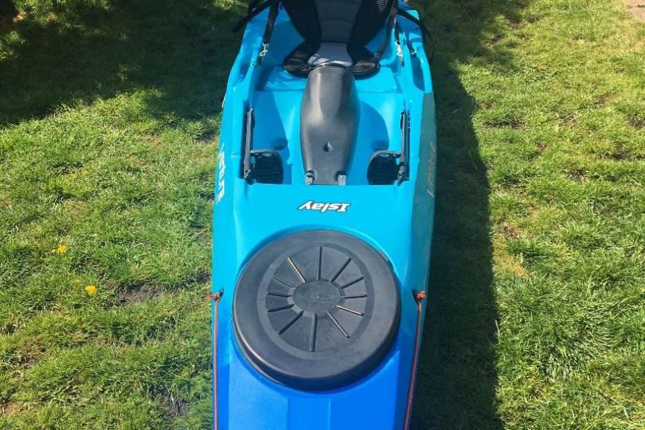 A blue kayak on grass Description automatically generated with medium confidence