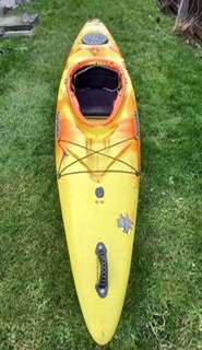 A yellow kayak on grass

Description automatically generated