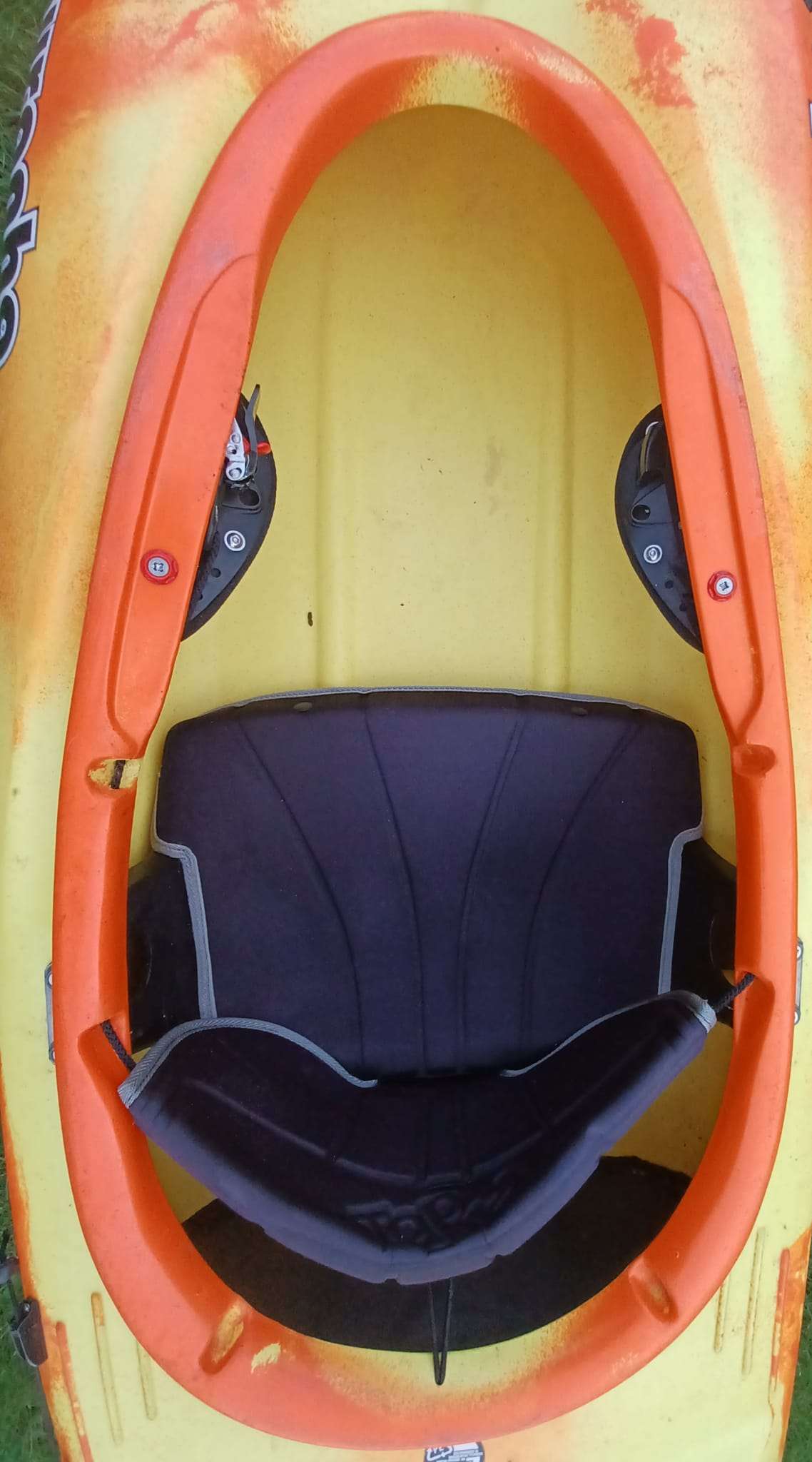 An inside of an orange kayak

Description automatically generated
